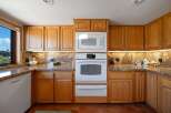 This stunning kitchen boasts beautiful wooden cabinetry and a modern appliance suite.