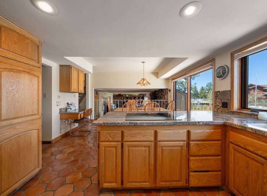 Step into this inviting kitchen, featuring a spacious island with a cooktop, perfect for culinary creations.