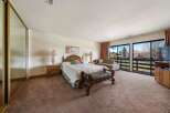 Step into luxury with this spacious bedroom featuring a comfortable bed, elegant nightstands, and a stylish bench.