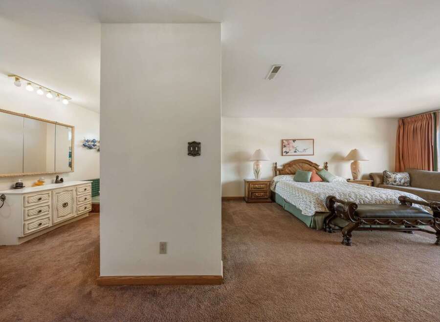 Step into this inviting bedroom, featuring a cozy ambiance and ample space.