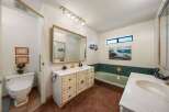 Step into this charming bathroom, featuring a vanity with ample storage and a stylish mirror.