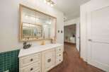 Step into this charming bathroom, featuring a vanity with ample storage and a stylish mirror.