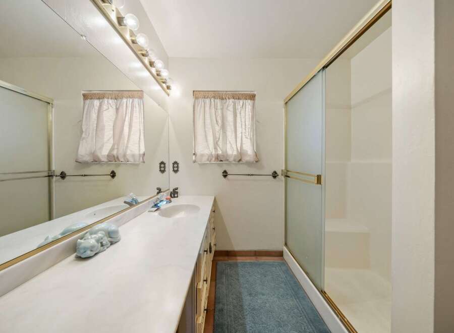 Step into this inviting bathroom featuring a spacious vanity with ample storage and a sleek design.