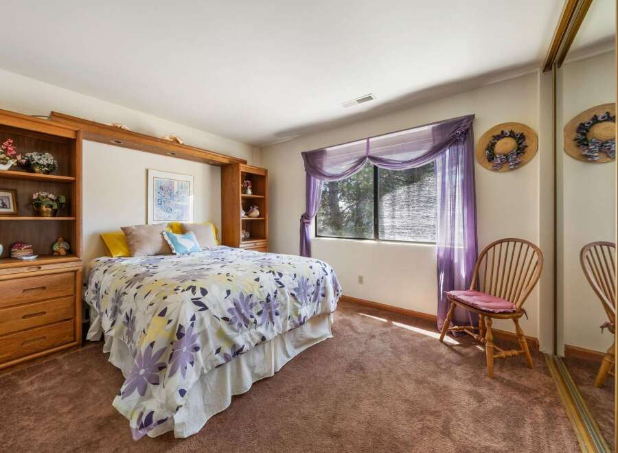 This charming bedroom offers a cozy retreat with its inviting ambiance and thoughtful design.