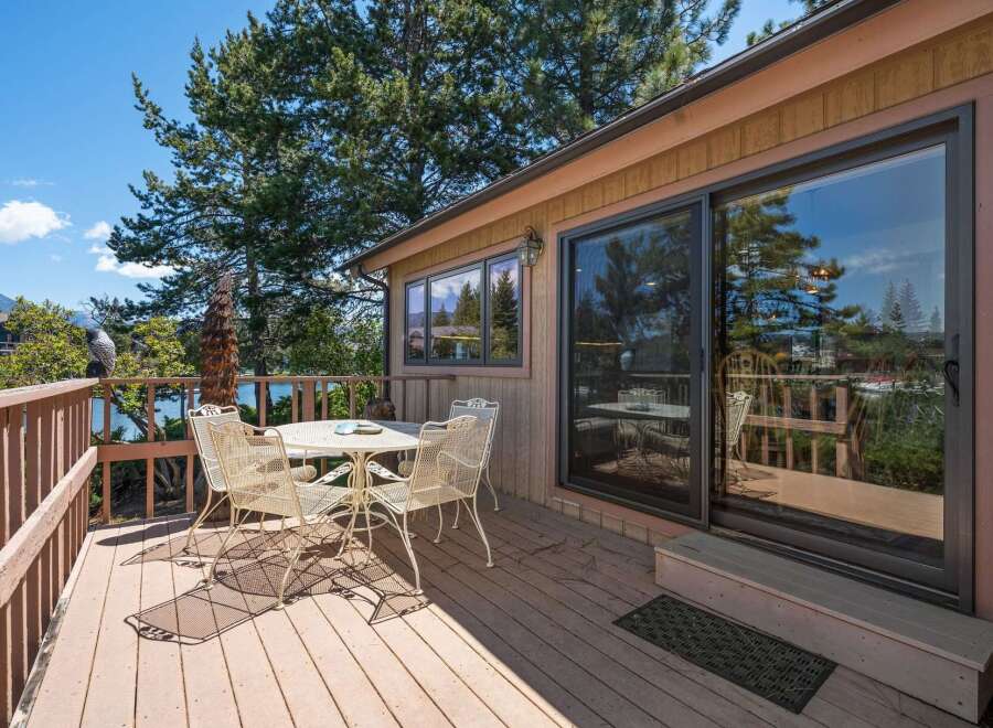 Enjoy breathtaking views from this stunning lakeside property! This home features a spacious deck perfect for entertaining or relaxing.