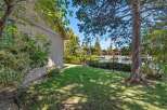 Discover waterfront living at its finest! This stunning property boasts a lush green lawn, mature trees, and direct access to the water.