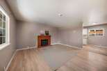 This inviting living space features a cozy brick fireplace, perfect for those chilly evenings.