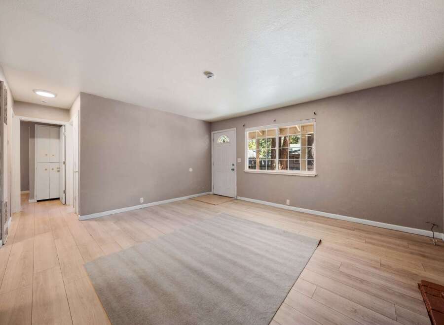 Step into this inviting living space, featuring a neutral color palette and ample natural light.