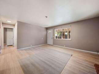 Step into this inviting living space, featuring a neutral color palette and ample natural light.