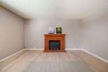This charming property features a cozy brick fireplace, perfect for creating a warm and inviting atmosphere.