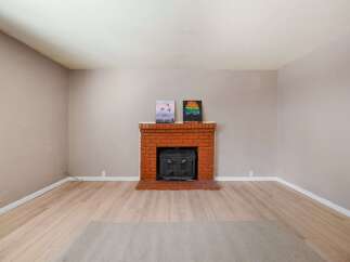 This charming property features a cozy brick fireplace, perfect for creating a warm and inviting atmosphere.