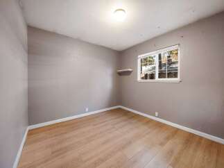 This inviting room features beautiful hardwood floors and neutral walls, creating a versatile space ready for your personal touch.