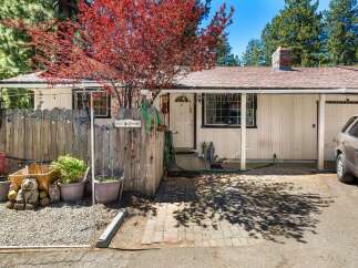 Charming home with a welcoming facade, featuring a well-maintained exterior and a lovely front yard.