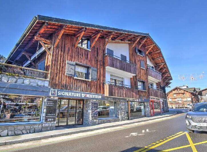 Discover this stunning property featuring a unique wooden facade and charming balconies.