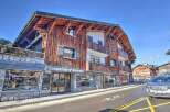 Discover this stunning property featuring a unique wooden facade and charming balconies.