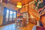 Discover the charm of this inviting property, featuring a cozy dining area with a wooden table and chairs, perfect for gatherings.