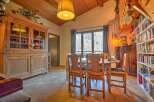 Step into this charming dining room, featuring a rustic wooden cabinet and a cozy dining set.