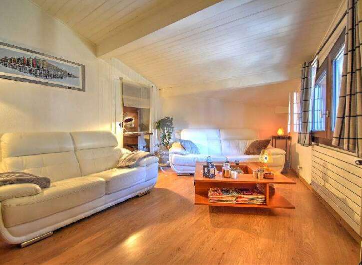 Discover the charm of this inviting living space, featuring a cozy white sofa and a stylish coffee table.