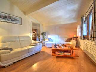 Discover the charm of this inviting living space, featuring a cozy white sofa and a stylish coffee table.