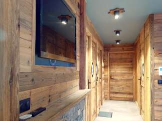 This stunning property boasts a warm and inviting interior, featuring beautiful wood paneling throughout.
