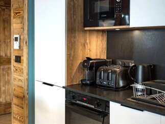 This modern kitchen boasts sleek appliances and a stylish design, perfect for culinary enthusiasts.