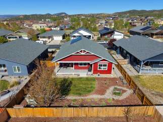 This stunning red home boasts a charming exterior and a welcoming atmosphere.