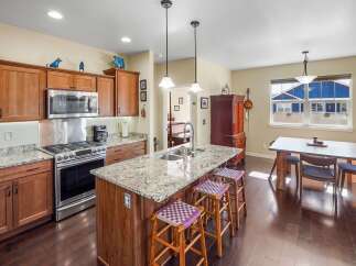 This stunning kitchen boasts a spacious island with a granite countertop, perfect for meal prep and entertaining.