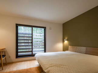 This inviting bedroom features a cozy bed with a textured comforter, perfect for relaxation.