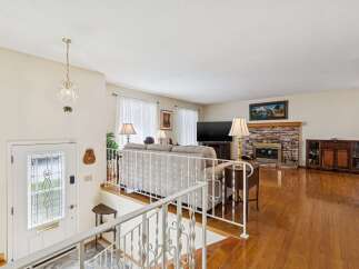 Step into this inviting home featuring a cozy living room with a fireplace, perfect for relaxing evenings.