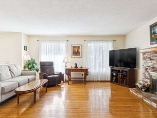 Step into this inviting living room, featuring a cozy fireplace and ample natural light.