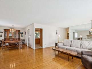 Step into this inviting home featuring a spacious living area with gleaming hardwood floors.