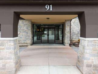 Welcome to this stunning property! This building features a beautiful stone facade and a welcoming entrance.