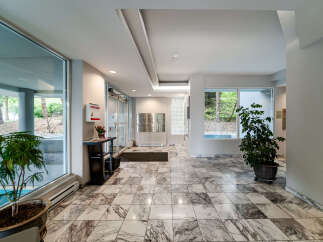 Step into the inviting lobby of this stunning property, showcasing a blend of modern design and natural light.