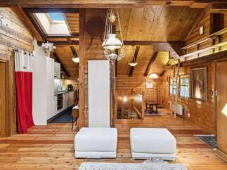 Step into rustic elegance with this stunning property, showcasing a warm, inviting interior.