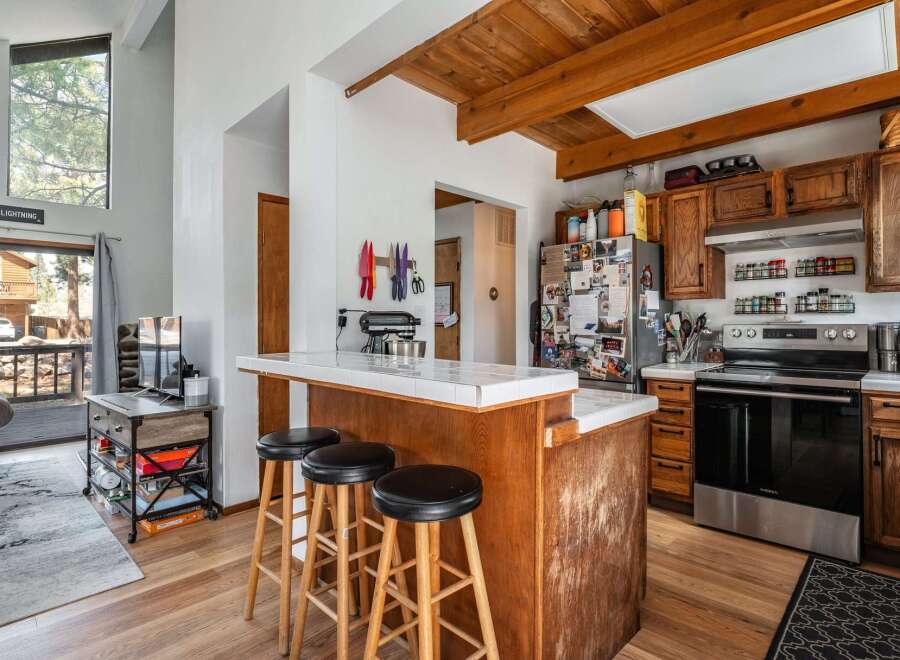 This charming kitchen boasts a cozy breakfast bar with seating, perfect for casual dining and entertaining.