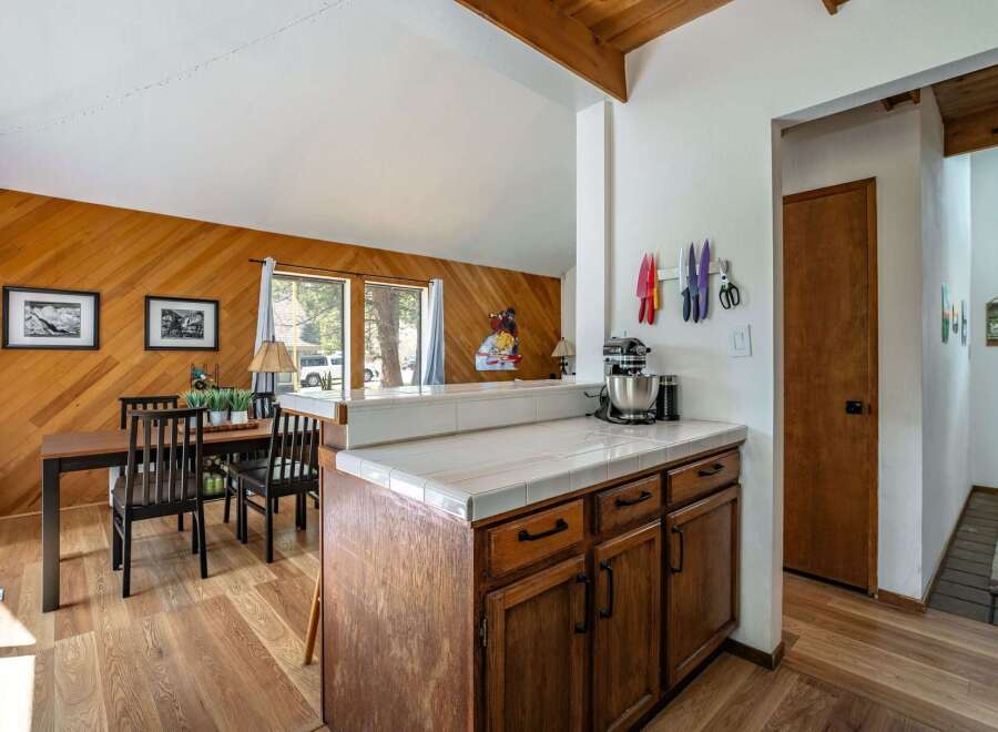 This charming kitchen features a warm, inviting atmosphere with its wooden cabinetry and flooring.