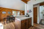 This charming kitchen features a warm, inviting atmosphere with its wooden cabinetry and flooring.