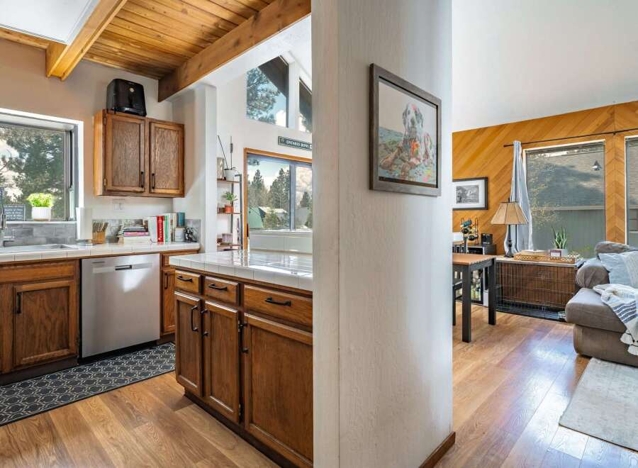 Step into this inviting home featuring a beautifully designed kitchen with wooden cabinetry and ample counter space.