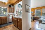 Step into this inviting home featuring a beautifully designed kitchen with wooden cabinetry and ample counter space.