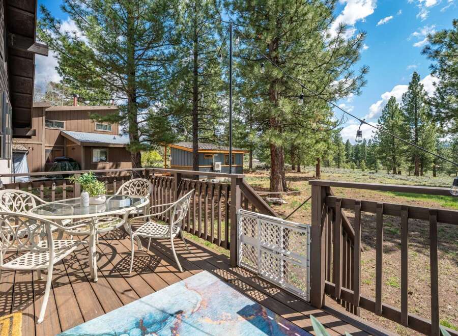 Enjoy the serene beauty of this property with a charming outdoor deck, perfect for relaxation and entertaining.