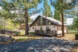 Nestled amidst towering trees, this charming home offers a serene escape.
