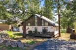 Nestled amidst towering trees, this charming home offers a serene retreat.