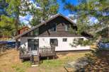 Nestled amidst towering trees, this charming home offers a serene retreat.