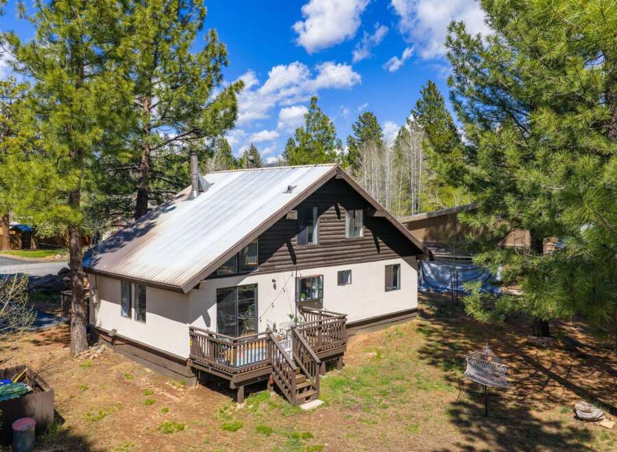 Nestled amidst towering trees, this charming home offers a serene escape.