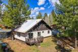 Nestled amidst towering trees, this charming home offers a serene escape.