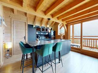 Experience luxury living in this stunning property featuring a modern kitchen with sleek cabinetry and a stylish island.
