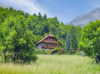 Nestled amidst lush greenery and majestic mountains, this stunning property offers a serene escape.
