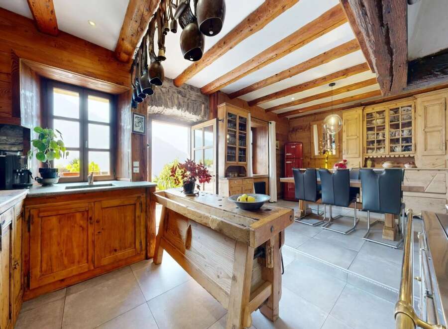 Step into rustic elegance with this stunning kitchen! Featuring exposed wooden beams, a charming wooden island, and a cozy dining area, this space is perfect for both cooking and entertaining.