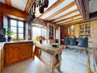 Step into rustic elegance with this stunning kitchen! Featuring exposed wooden beams, a charming wooden island, and a cozy dining area, this space is perfect for both cooking and entertaining.