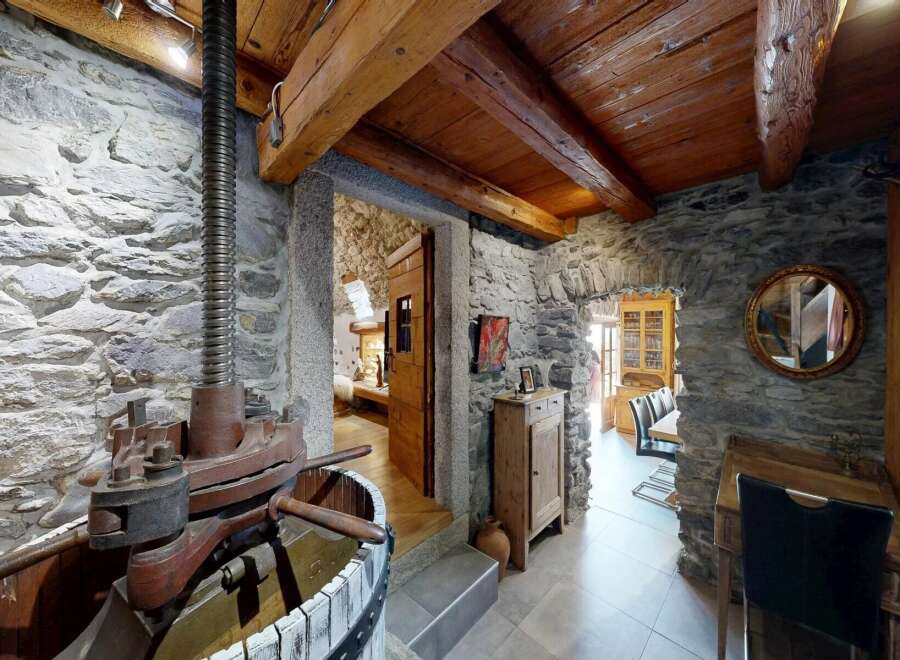 Step into rustic charm with this stunning property featuring exposed stone walls and wooden beams.